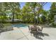 Backyard pool and patio area shaded by mature trees at 739 Wildwood Rd, Charleston, SC 29412