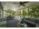 The screened porch features a conversation area with view to outdoor living space at 739 Wildwood Rd, Charleston, SC 29412
