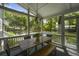 The screened porch features a dining table with a view of the pool and backyard at 739 Wildwood Rd, Charleston, SC 29412
