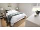 Serene bedroom with a white bed, striped bedding, and a bright window at 7621 Indigo Palms Way, Johns Island, SC 29455