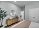 Bedroom showcasing woven dresser with round mirror, green plant, and modern interior design at 7621 Indigo Palms Way, Johns Island, SC 29455