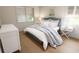Cozy bedroom featuring neutral tones, two windows with blinds, and an elegant headboard at 7621 Indigo Palms Way, Johns Island, SC 29455
