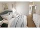Inviting bedroom featuring a blue headboard, plush pillows, and a dresser at 7621 Indigo Palms Way, Johns Island, SC 29455