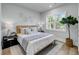 Comfortable bedroom with large window, stylish lamps, and decorative wall art creating a serene atmosphere at 7621 Indigo Palms Way, Johns Island, SC 29455
