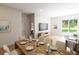 Dining room with a large window, view of the backyard, and a modern entertainment center at 7621 Indigo Palms Way, Johns Island, SC 29455