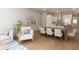 Open dining area featuring a large table, seating for eight, and neutral decor at 7621 Indigo Palms Way, Johns Island, SC 29455