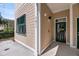 Exterior view of the home entrance, showing the door and window at 7621 Indigo Palms Way, Johns Island, SC 29455