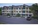 Exterior shot of condo building featuring multiple balconies and lush landscaping in a well maintained parking lot at 7621 Indigo Palms Way, Johns Island, SC 29455