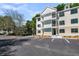 Apartment Building, showing well-maintained property with ample parking and landscaped grounds at 7621 Indigo Palms Way, Johns Island, SC 29455