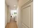 Bright hallway with hardwood floors leading to an open-concept kitchen and dining area at 7621 Indigo Palms Way, Johns Island, SC 29455