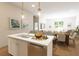 Bright kitchen with an island sink, stainless steel appliances, and pendant lighting at 7621 Indigo Palms Way, Johns Island, SC 29455
