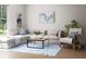 Cozy living area with a sectional sofa, modern coffee table, and neutral color palette at 7621 Indigo Palms Way, Johns Island, SC 29455