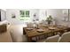 Open concept room with a dining table, living room with a large window, and stylish decor at 7621 Indigo Palms Way, Johns Island, SC 29455