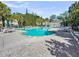 Spacious community pool surrounded by trees and patio furniture at 7621 Indigo Palms Way, Johns Island, SC 29455