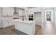 Modern kitchen features white cabinets, an island with marble countertops, and stainless steel appliances at 767 Maynard Ln, Summerville, SC 29486