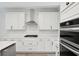 Bright kitchen features white cabinets, stainless steel appliances, and tile backsplash at 767 Maynard Ln, Summerville, SC 29486
