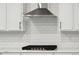 Modern kitchen features a stainless steel range hood and white cabinets with a tile backsplash at 767 Maynard Ln, Summerville, SC 29486