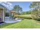 A well-maintained backyard features a concrete patio with an outdoor table and umbrella for shade at 777 Hamlet Cir, Goose Creek, SC 29445