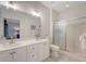 Bright bathroom featuring double vanity, white cabinets, a glass-enclosed shower, and access to an additional bedroom at 777 Hamlet Cir, Goose Creek, SC 29445