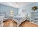 Bright bedroom with blue walls, wood floors, and a ceiling fan at 777 Hamlet Cir, Goose Creek, SC 29445