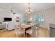 Bright dining area features hardwood floors, wainscotting, and views into the living area and through the adjacent window at 777 Hamlet Cir, Goose Creek, SC 29445