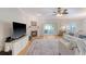 Bright living room with a fireplace, ceiling fan, and access to the patio at 777 Hamlet Cir, Goose Creek, SC 29445