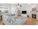 Open-concept living area featuring a fireplace, plush seating, and hardwood floors at 777 Hamlet Cir, Goose Creek, SC 29445