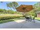 Back patio featuring table and chairs, large umbrella, and expansive, green backyard at 777 Hamlet Cir, Goose Creek, SC 29445