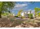 Expansive backyard with lush green grass, mature trees, and a view of the home's back exterior at 79 Rivers Point, Charleston, SC 29412