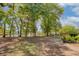 Large backyard featuring mature trees and partial fencing, backing onto a waterway at 79 Rivers Point, Charleston, SC 29412