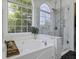 Bright bathroom featuring a soaking tub and a glass-enclosed shower with marble accents at 79 Rivers Point, Charleston, SC 29412