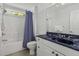 Well-lit bathroom with a blue marble countertop vanity and tiled shower-tub combination at 79 Rivers Point, Charleston, SC 29412