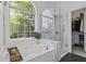 Bright bathroom featuring a soaking tub and a glass-enclosed shower with marble accents at 79 Rivers Point, Charleston, SC 29412