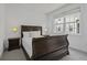 Cozy bedroom with natural light, a wooden sleigh bed, and neutral carpet at 79 Rivers Point, Charleston, SC 29412