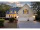 Inviting two-story home with a well-manicured lawn, a cozy front porch, and an attached two-car garage at 79 Rivers Point, Charleston, SC 29412