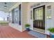 Covered front porch with a black door, sidelights, potted plants, and black shutters at 79 Rivers Point, Charleston, SC 29412