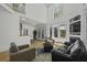 Bright living room boasting a fireplace, hardwood floors, large windows, and high ceilings at 79 Rivers Point, Charleston, SC 29412