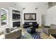 Open-concept living room with a fireplace, large mirror, comfortable seating, and high ceilings at 79 Rivers Point, Charleston, SC 29412