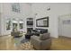 Sunlit living room featuring a fireplace, hardwood floors, high ceilings, and backyard views at 79 Rivers Point, Charleston, SC 29412