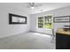 A spacious home office is illuminated by a large window with scenic backyard views at 79 Rivers Point, Charleston, SC 29412