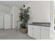 A home's upstairs wet bar features a granite countertop and convenient storage space at 79 Rivers Point, Charleston, SC 29412