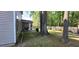 Well-maintained backyard featuring a screened porch, mature trees, and a privacy fence at 8107 Old London Rd, North Charleston, SC 29406