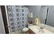 Bathroom area featuring a pattern shower curtain, white sink and grey walls at 8107 Old London Rd, North Charleston, SC 29406
