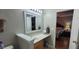 Bright bathroom with a white countertop, wooden cabinets, and view to a bedroom at 8107 Old London Rd, North Charleston, SC 29406