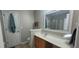 Well-lit bathroom with a vanity, large mirror, and linen closet at 8107 Old London Rd, North Charleston, SC 29406