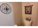 Cozy powder room featuring neutral walls and decorative wall art at 8107 Old London Rd, North Charleston, SC 29406