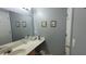 Bathroom vanity and mirror with neutral decor and a white door at 8107 Old London Rd, North Charleston, SC 29406
