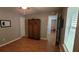 Bedroom with neutral walls, wood floors, closet and an antique cabinet at 8107 Old London Rd, North Charleston, SC 29406