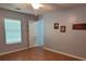 This bedroom features wood flooring, a ceiling fan and light, and a door to another room at 8107 Old London Rd, North Charleston, SC 29406