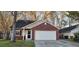 Traditional home with brick accents, attached garage, manicured lawn, and mature trees for curb appeal at 8107 Old London Rd, North Charleston, SC 29406